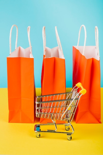 Free photo sales concept with cart in front of bags