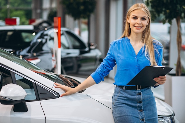 Sales woman in a car showroom