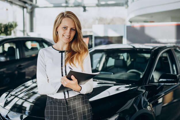 Sales woman in a car shworoom