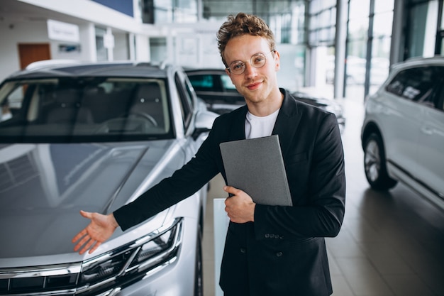 Salesman at a car showroom