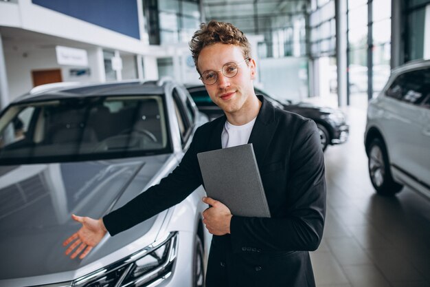 Salesman at a car showroom