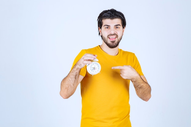 A salesman holding and promoting the alarm clock.