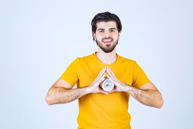 A salesman holding and promoting the alarm clock.