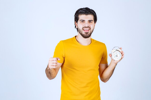 A salesman holding and promoting the alarm clock.