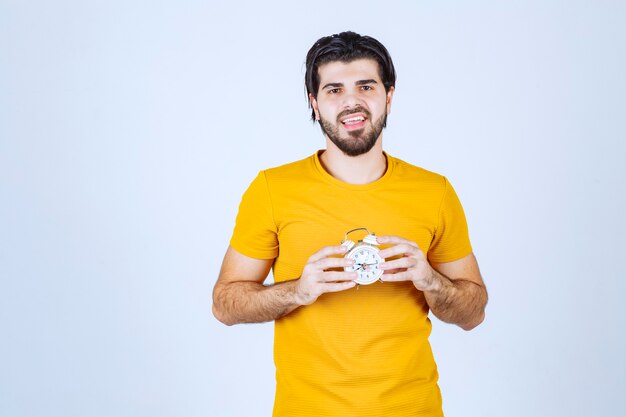 A salesman holding and promoting the alarm clock.