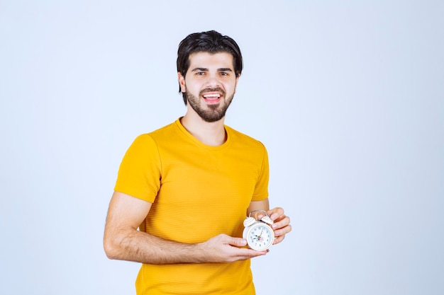 A salesman holding and promoting the alarm clock.