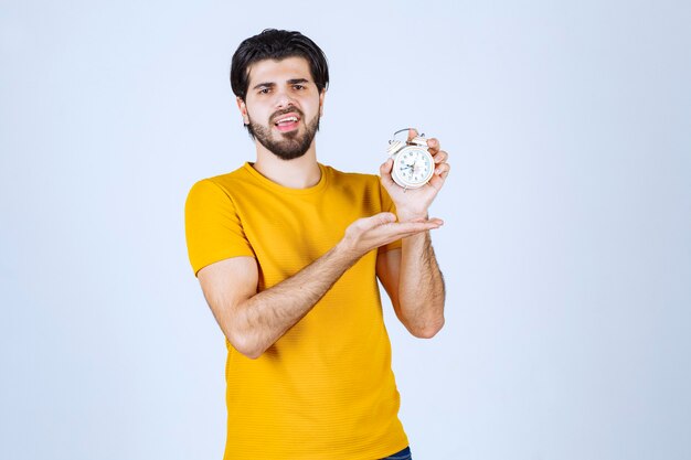 A salesman holding and promoting the alarm clock.