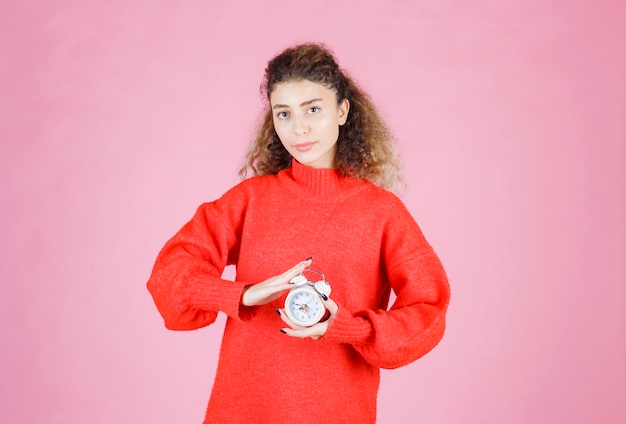 A saleswoman holding and promoting new alarm clock.