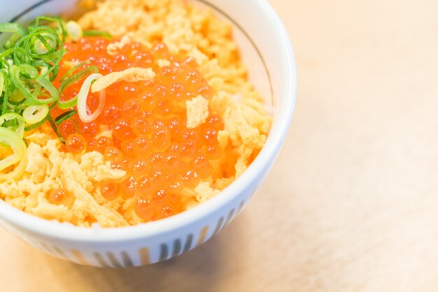 Salmon eggs on top of rice bowl