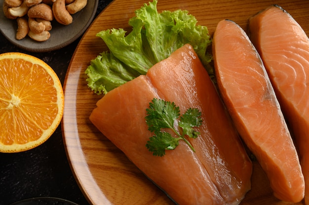 Salmon pieces on a wooden plate. selective focus.