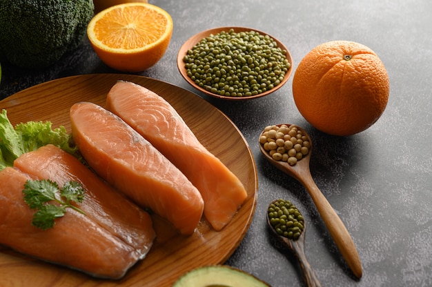 Free photo salmon pieces on a wooden plate. selective focus.