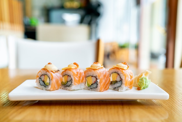 Salmon roll sushi with cheese on top - japanese food style