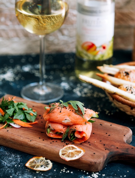 Salmon rolls with glass of white wine