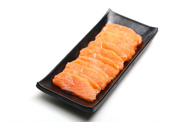 salmon slices in black plate on white background