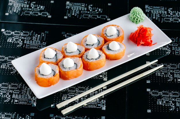 Salmon sushi rolls topped with japanese mayonnaise