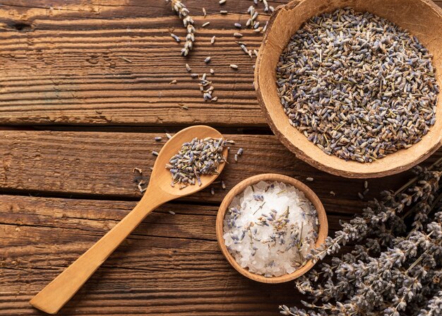 Salt and lavender crushed leaves on wooden background