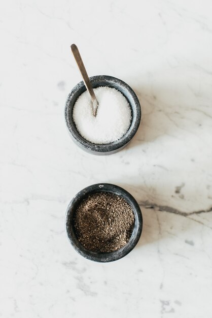 salt and pepper on white table