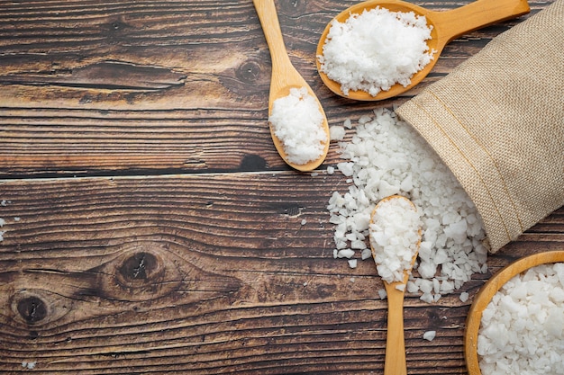 salt in wooden spoon place on floor