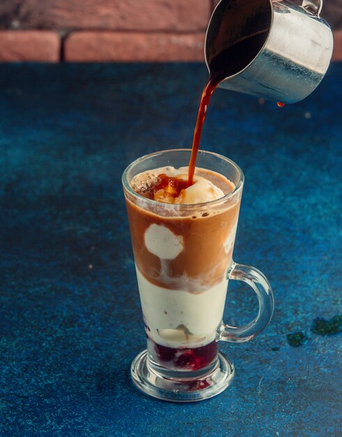 salted caramel milkshake in a glass in navy background