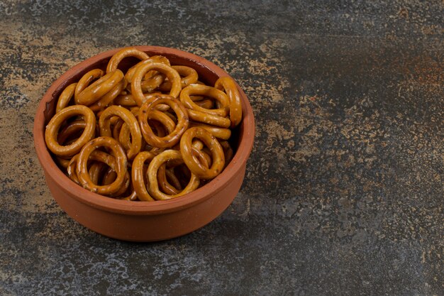 Salted circle pretzels in ceramic bowl.