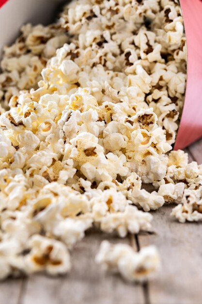 Salted popcorn on wooden table