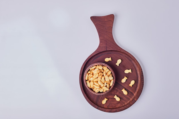 Salty crackers in a wooden cup,  top view.