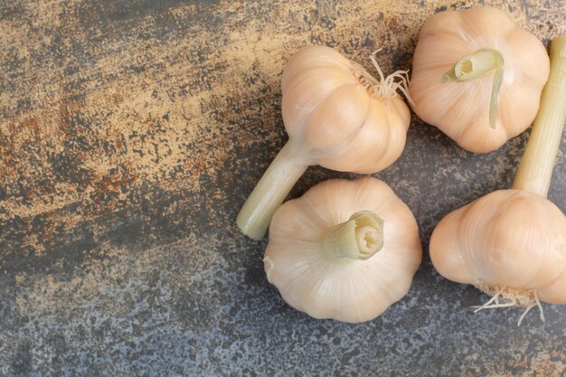 Salty delicious garlics on marble background. High quality photo