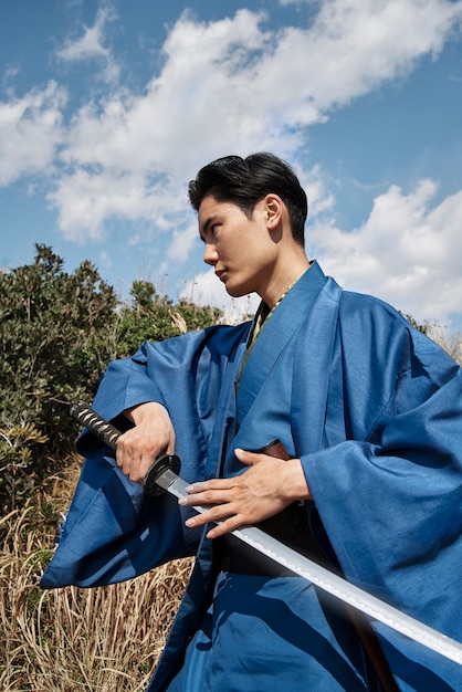 Samurai with sword outdoors