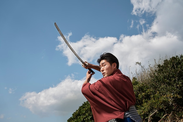 Samurai with sword outdoors