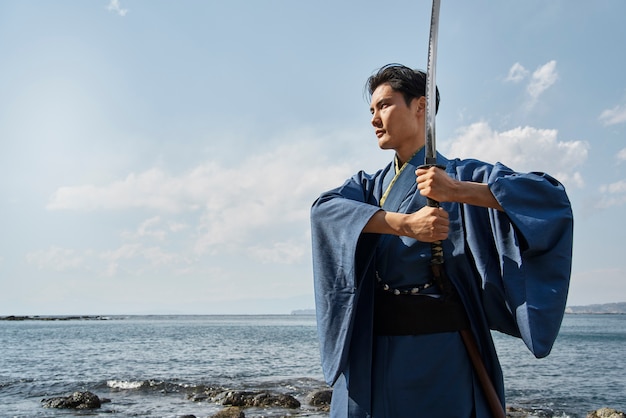 Free photo samurai with sword outdoors