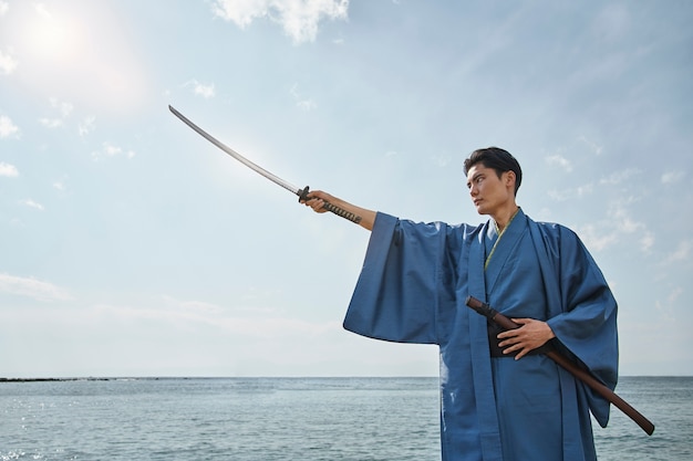 Free photo samurai with sword outdoors