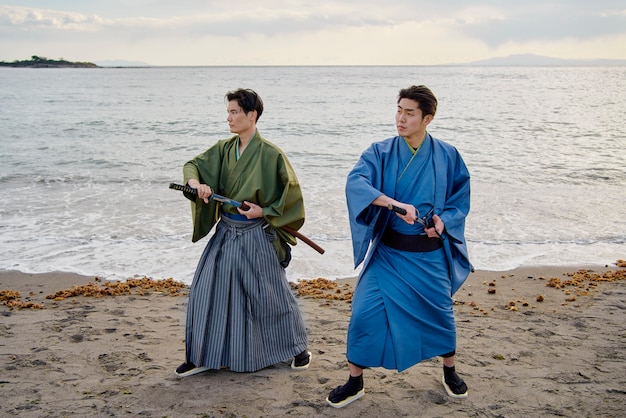 Free photo samurais at the beach