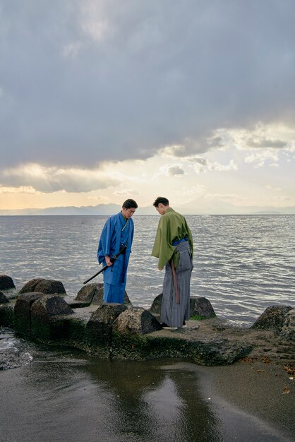 Samurais taking a bow on the beach