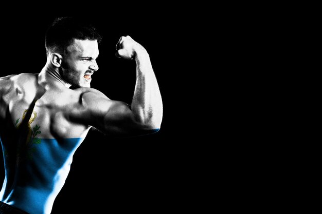 San Marino flag on handsome young muscular man black background