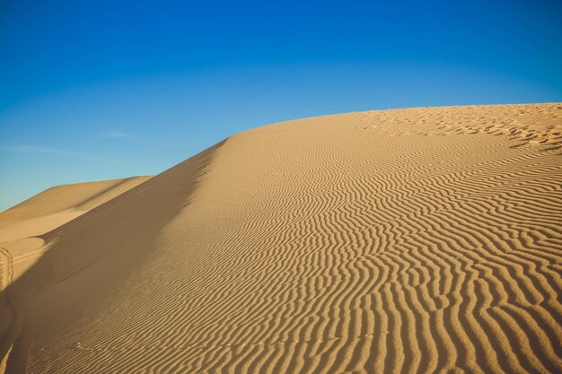 Sand dunes at sunset casting nice shadows in Muine Vietnam