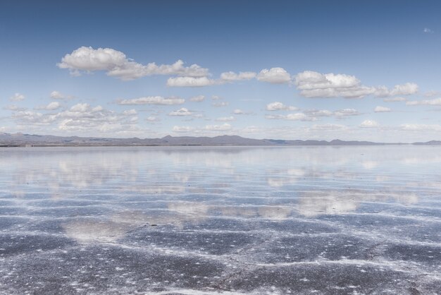 Sand texture visible under the crystal clear sea and the sky