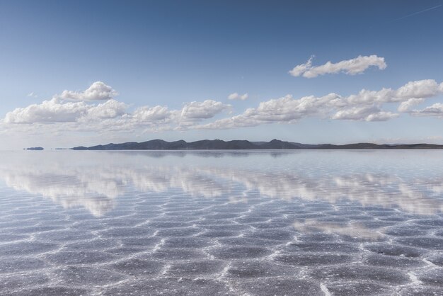 Sand texture visible under the crystal clear sea and the sky