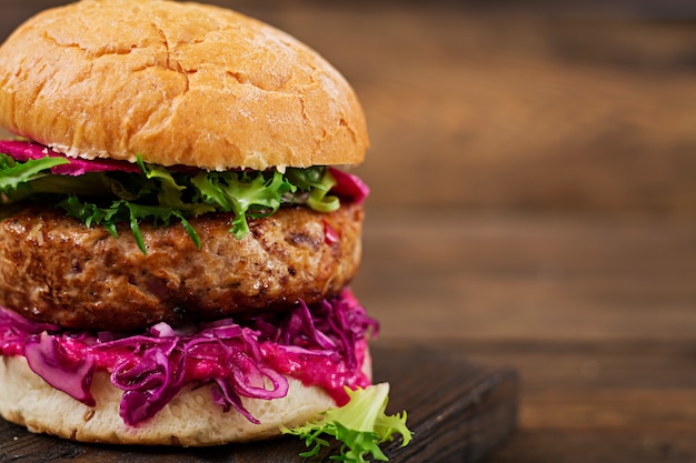 Sandwich hamburger with juicy burgers, red cabbage and pink sauce