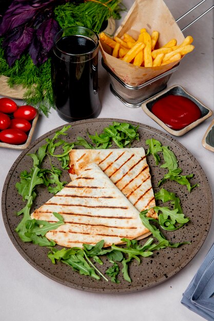 Sandwich in lavash served with french fries ketchup