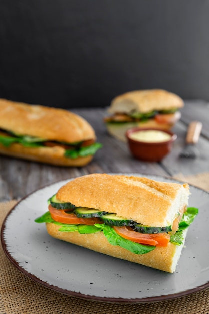 Sandwich on plate with tomato and cucumber slices