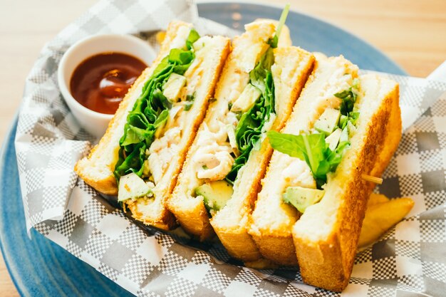 Sandwich with avocado and chicken meat with french fries