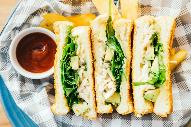 Sandwich with avocado and chicken meat with french fries