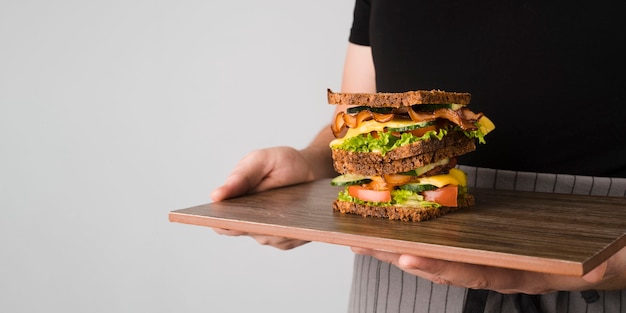 Sandwich with bacon on wooden board