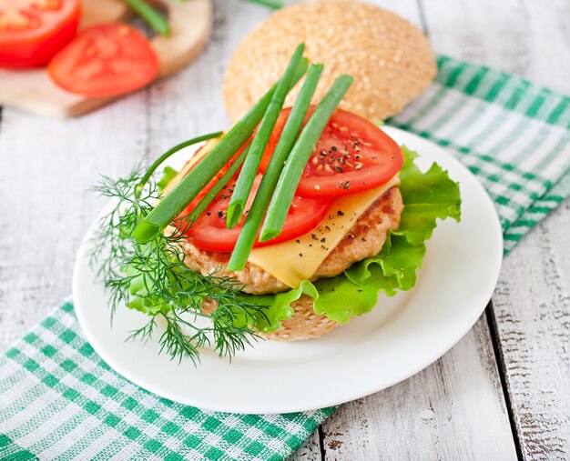 Sandwich with chicken burger, tomatoes, cheese and lettuce