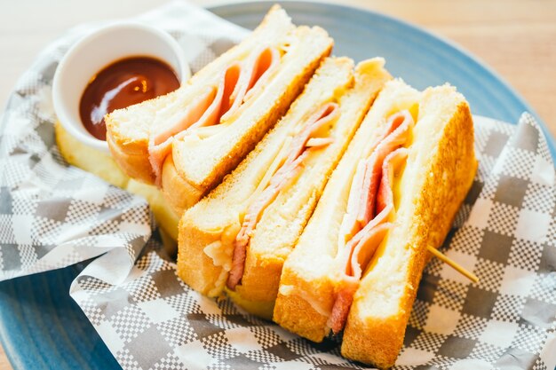 Sandwich with ham cheese and french fries and tomato sauce