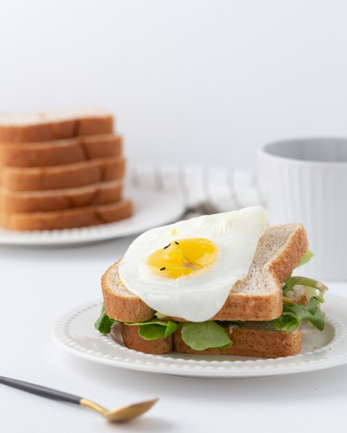 Sandwich with lettuce and fried egg