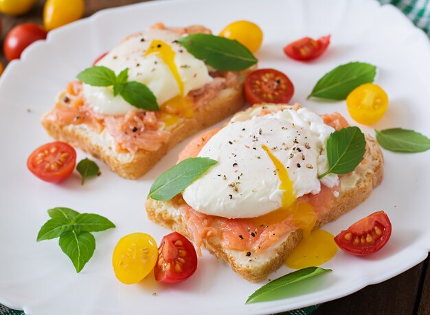 Sandwich with poached eggs with salmon and cream cheese