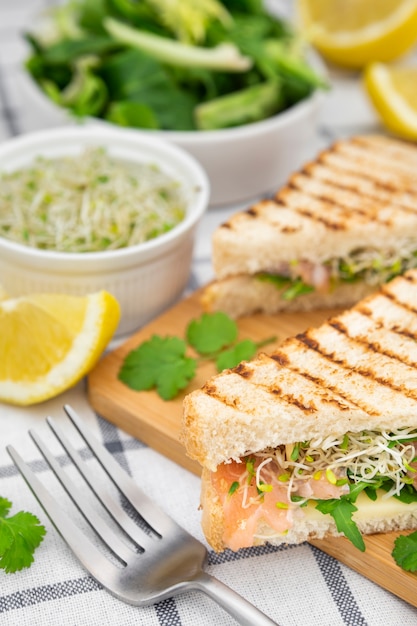 Free photo sandwich with sprouts and fork