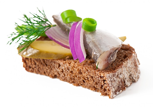 Sandwiches of rye bread with herring, onions and herbs.