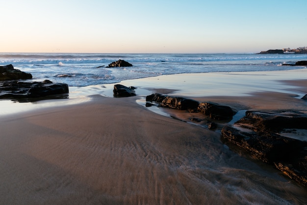 Sandy beach with a clear blue sky during daytime